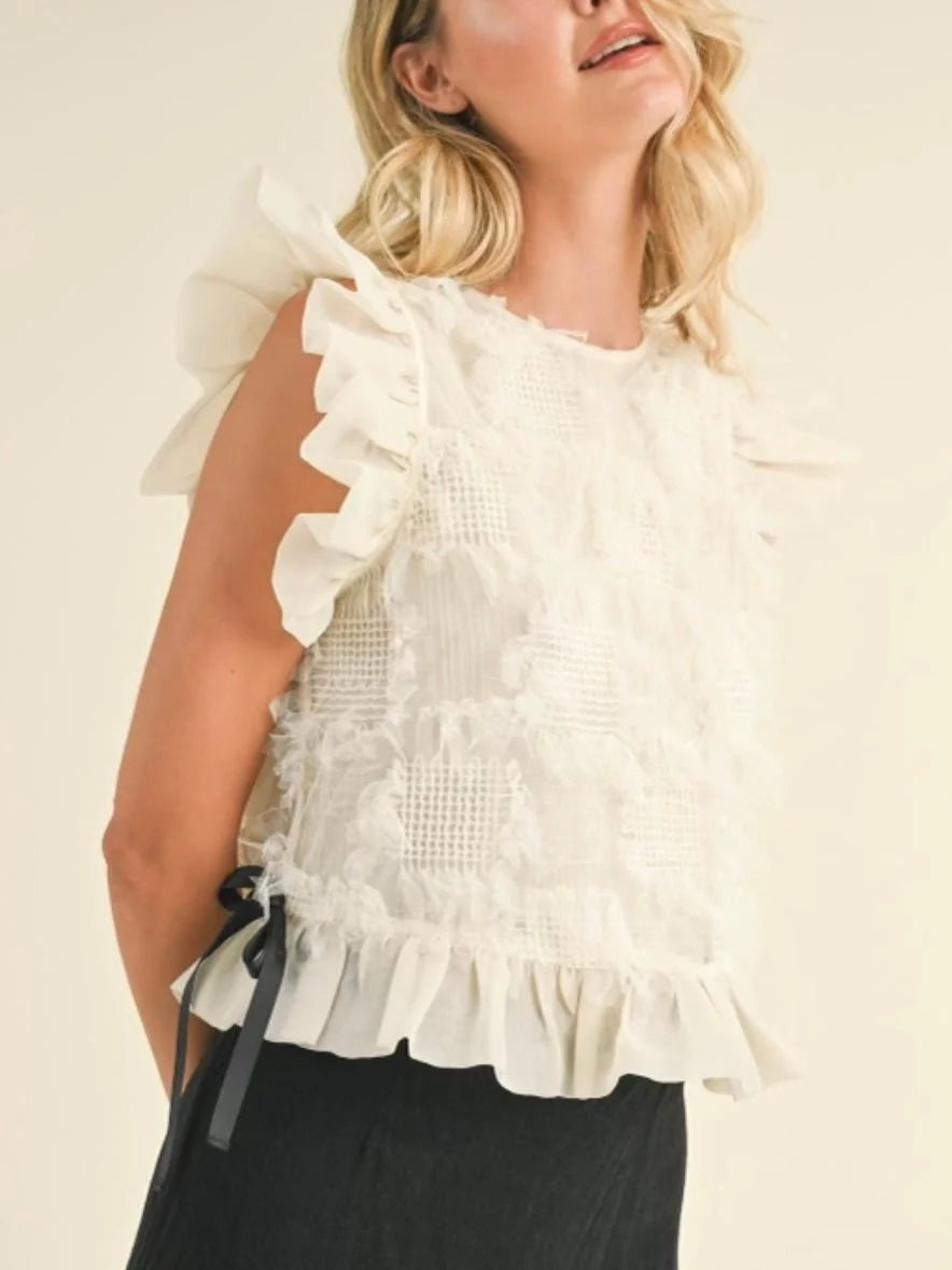 Cream ruffle top with black details